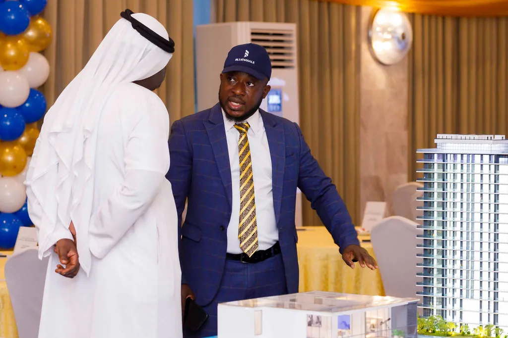 A project representative discussing the development model with an international guest