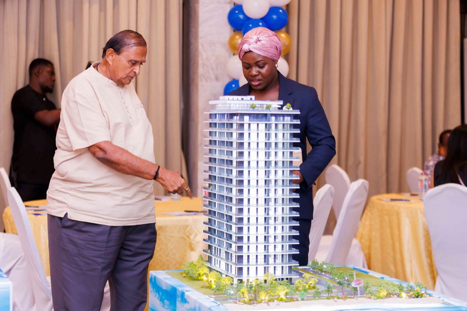 A project representative and guest discussing an Oriental Royal Estates development model